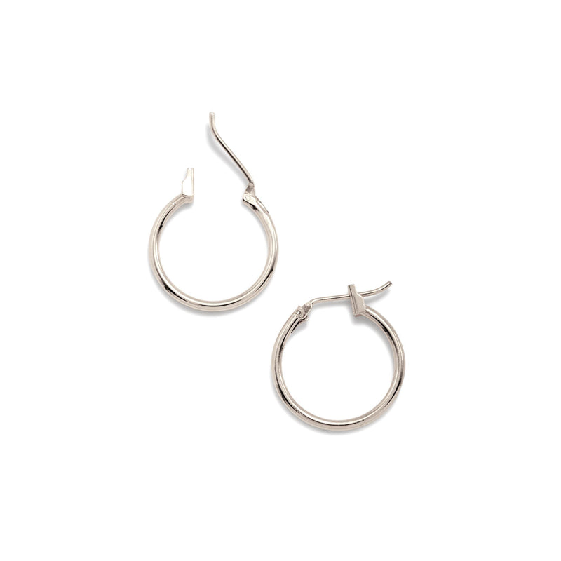 Two argent Kahlo créole Click-Top boucles d'oreilles xs par JAREDJAMIN Bijoux en Ligne are montré sur a fond blanc—one boucle d'oreille lies flat avec the latch closed, while the other highlights its click-top closure mechanism.