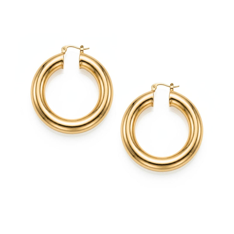 High-resolution studio product shot of both Aurelia chubby gold hoops resting flat, highlighting their circular 1.5-inch geometry, high-shine polish, and hinge mechanisms.