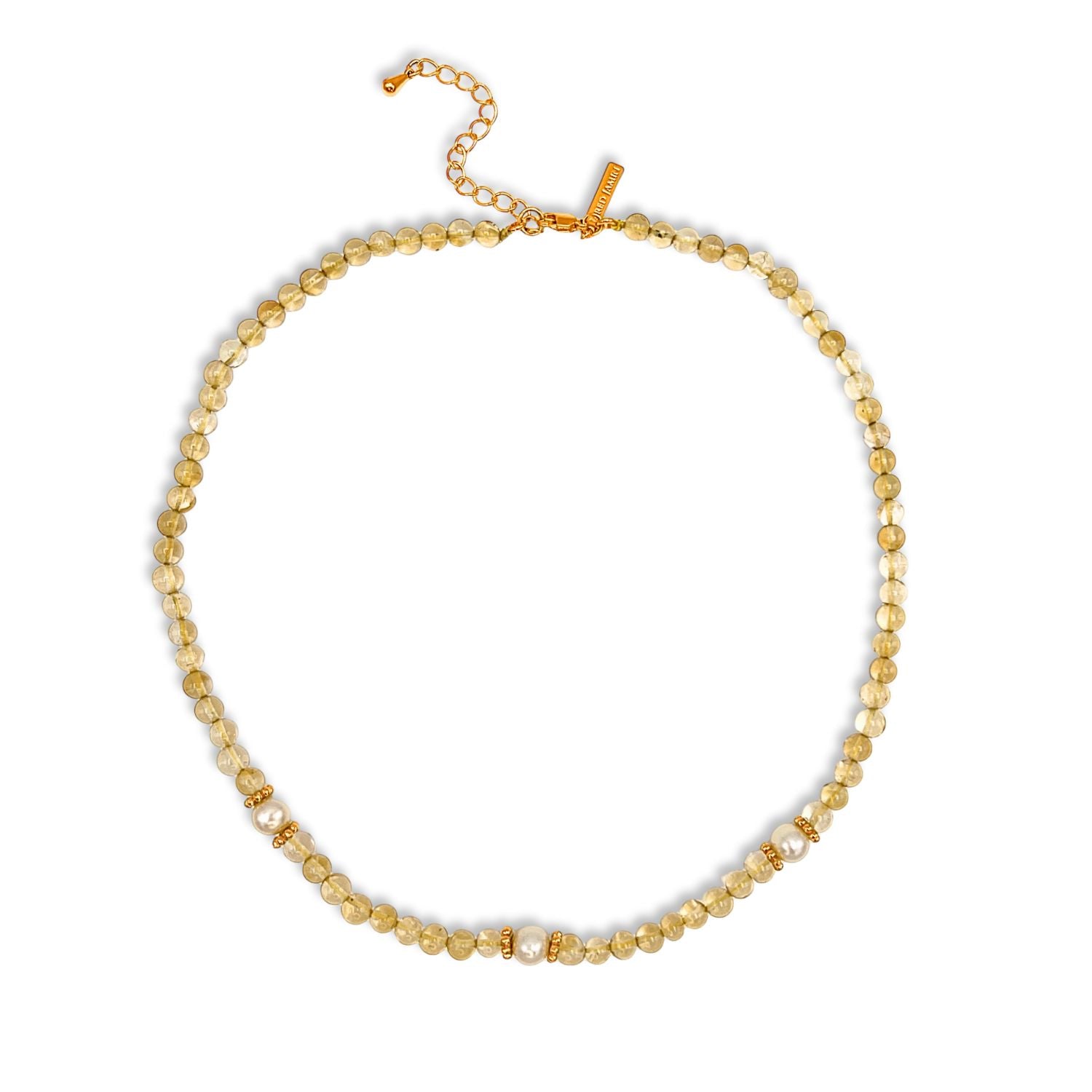 The Sand Bar Sensation Citrine Necklace by JAREDJAMIN Jewelry Online features round, translucent yellow-gold citrine beads separated by metallic gold spacers with rhinestone accents and an adjustable gold chain clasp with a rectangular tag.