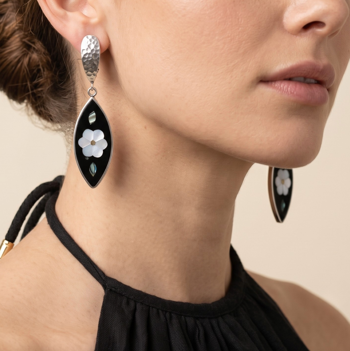 High-resolution studio product shot of the pair of Esperanza Upcycled Inlaid Earrings displayed against a white background, highlighting their black onyx marquise shape, central mother-of-pearl flower, and hammered clip tops.