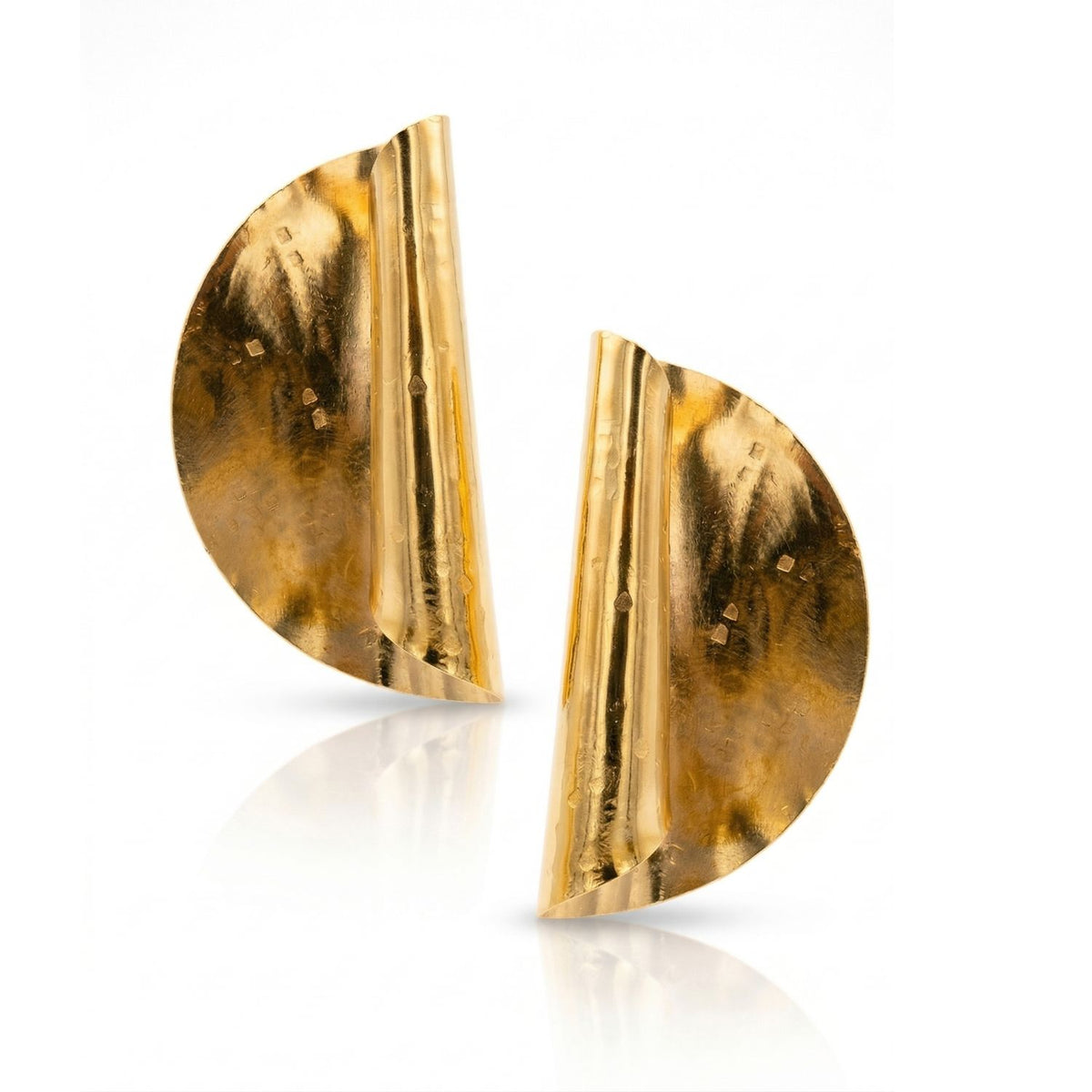 Large Scroll Earrings—hand-assembled in our West Hollywood studio—capture light across sculpted, asymmetrical curves. Forged from small-batch, eco-conscious 18k gold plate. Style Note: punctuates tailored blazers or elevates after-dark silks. Shown against white.