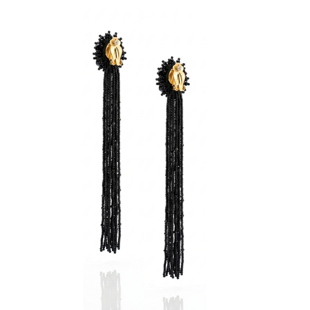 The Serafina Beaded Clip Earrings by JAREDJAMIN Jewelry Online feature gold-toned hand-shaped studs, black glass crystal beads, and layered beaded tassel strands, shown against a white background.