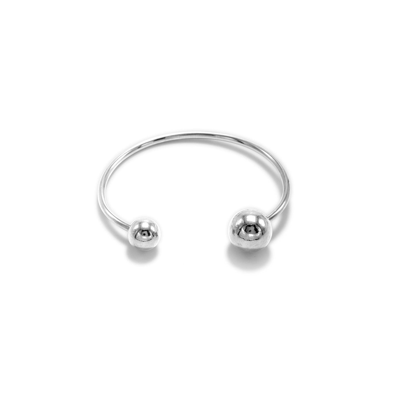 The Silver Orbita Bracelet by JAREDJAMIN Jewelry Online features a minimalist white rhodium-plated cuff with a polished finish and two rounded ball ends, shown on a plain white background to highlight its sleek, modern design.