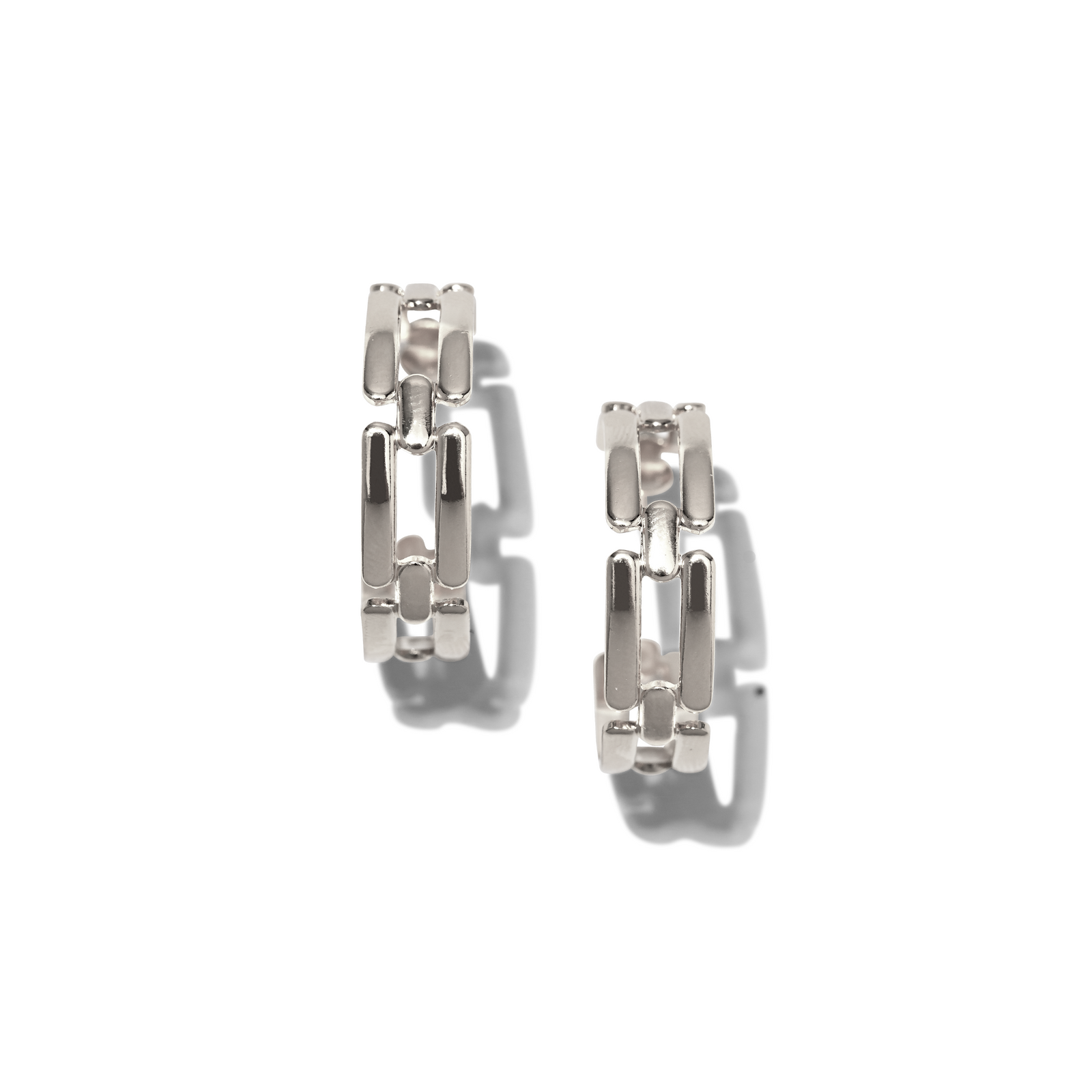The Silver Bravura Chain Hoop Post Earrings by JAREDJAMIN Jewelry Online feature a chunky, interlocking link design and silver plating, presented on a white background with soft gray shadows that highlight their platinum-inspired geometric structure.