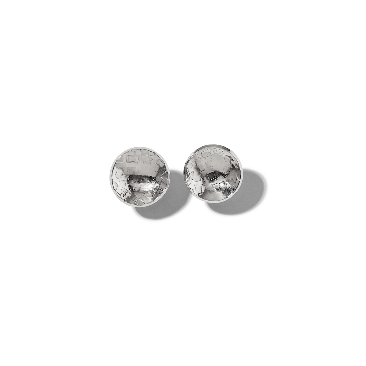 A pair of Buttercup Textured Stud Post Earrings by JAREDJAMIN Jewelry Online, featuring a hammered, concave silver surface with a shiny, reflective finish. The stud earrings are displayed side by side on a white background with soft shadows.