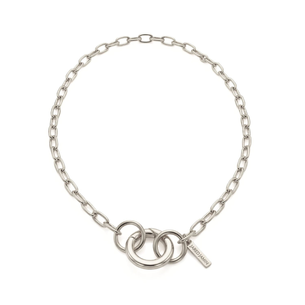 Hand-assembled in our West Hollywood studio, the Silver Chain Reaction Connector Necklace sculpts recycled silver into oval links and twin interlocking rings—punctuated by a signature tag. Style Note: anchors minimalist to sharp tailoring or after-dark suiting.