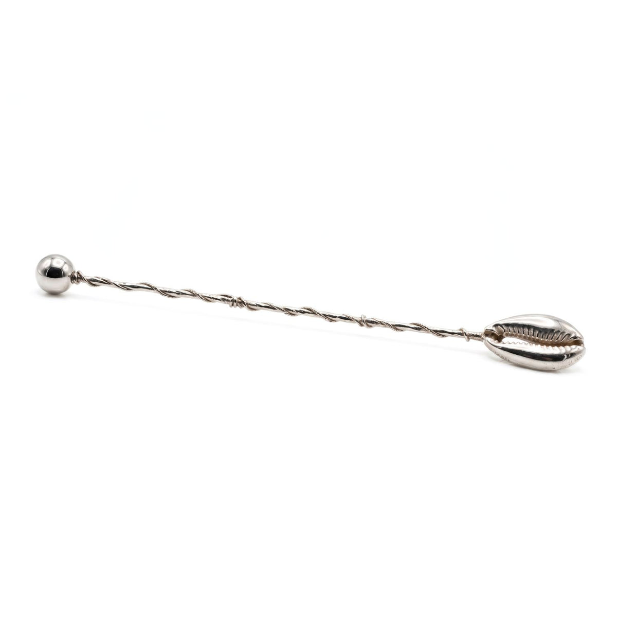 Minimalist studio product shot of the JAREDJAMIN Silver Cowrie Cocktail Stirrer laid out horizontally, showcasing the heavy silver-plated organic twisted wire stem, the detailed 1 1/8-inch cowrie shell basin on the right, and the polished spherical ball finial on the left.