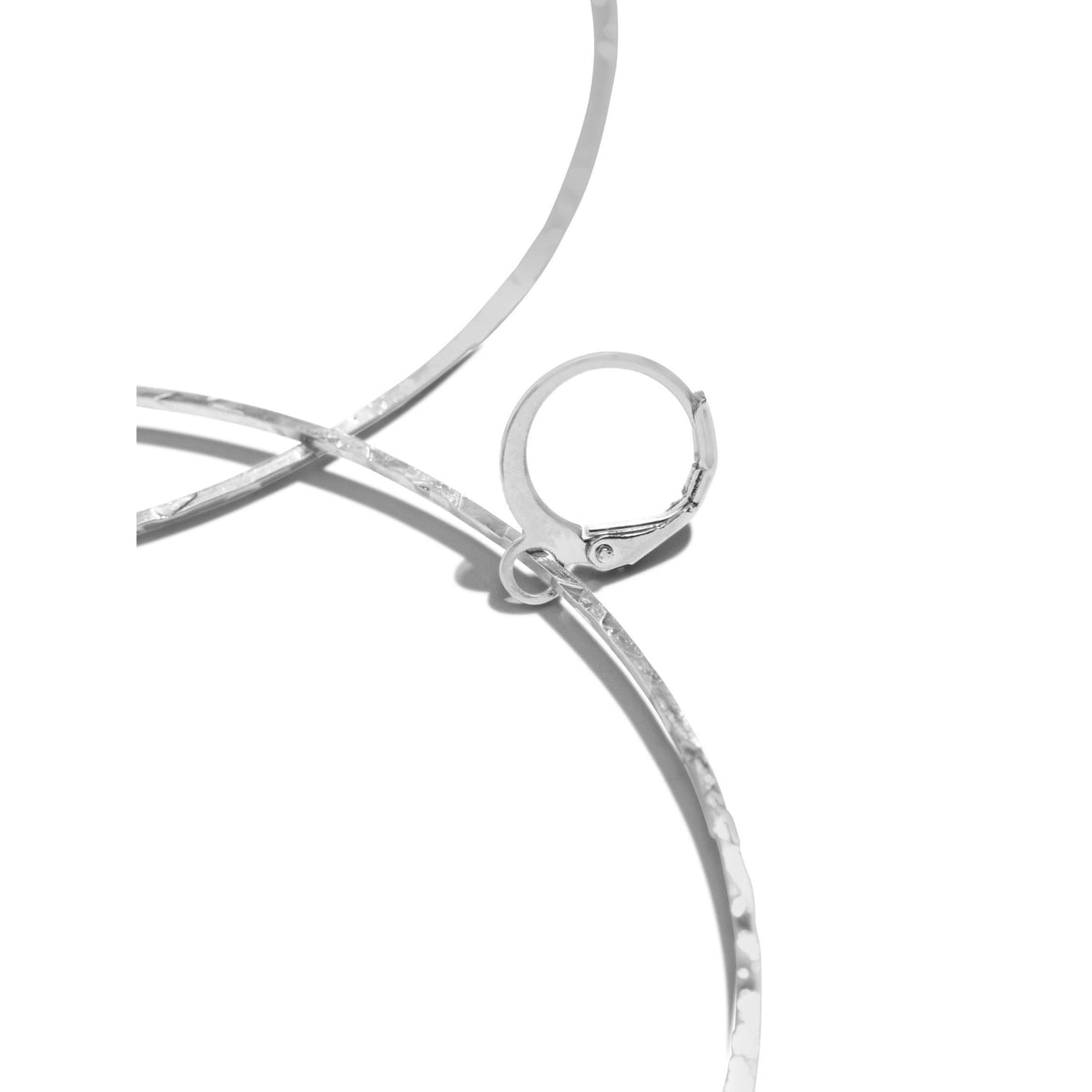 Close-up of JAREDJAMIN Jewelry Online’s Silver Halo Textured Hoop Earrings, showing rhodium-plated silver with a hammered surface and latch-back clasp against a white background; another partial hoop suggests a pair, while shadows enhance their platinum-like shine.