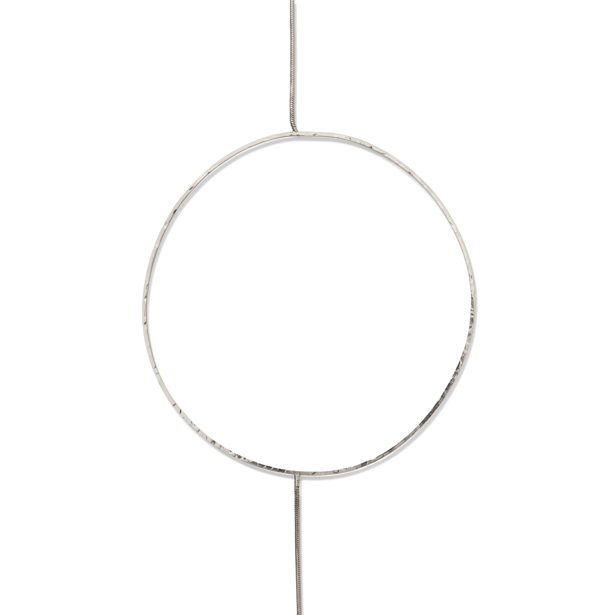 The Silver Halo Necklace by JAREDJAMIN Jewelry Online features a large, thin silver hoop intersected by a slender rod in a platinum/silver tone, showcased against a plain white background for a simple, minimalistic geometric look.