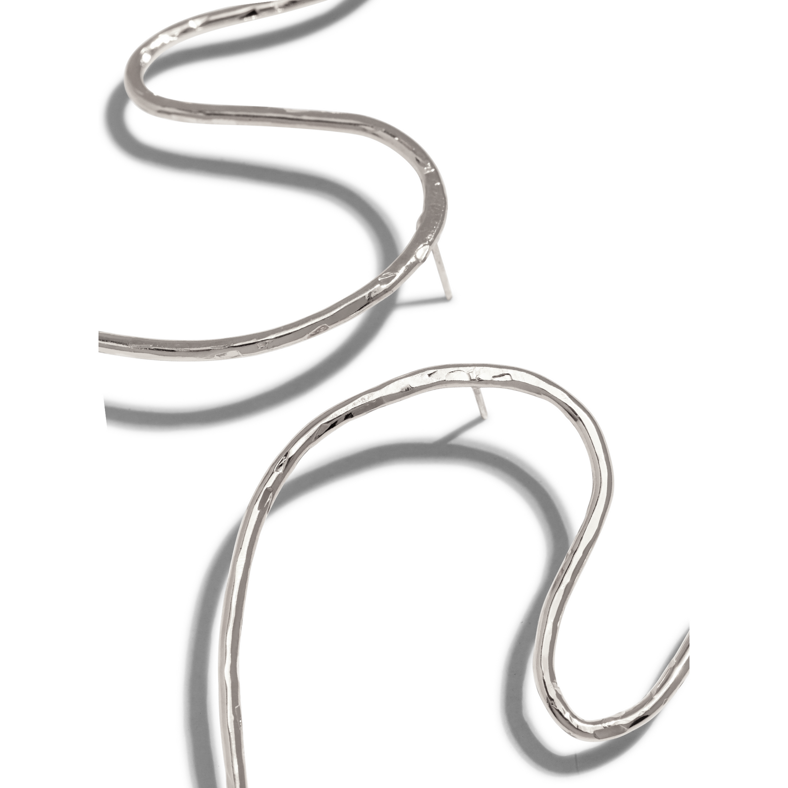 Two Silver Large Fluttering Heart earrings by JAREDJAMIN Jewelry Online feature smooth, handmade silver plate wire forming open hearts on a plain white background, spaced diagonally and similar in size.