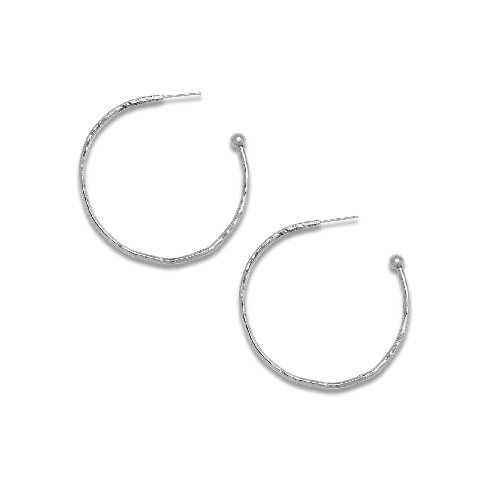 The JAREDJAMIN Jewelry Online Silver Medium Hooptastic Hoop Post Earrings feature thin, silver, white rhodium-plated hoops with a subtle hammered texture and small sphere tips. Displayed diagonally on a white background.