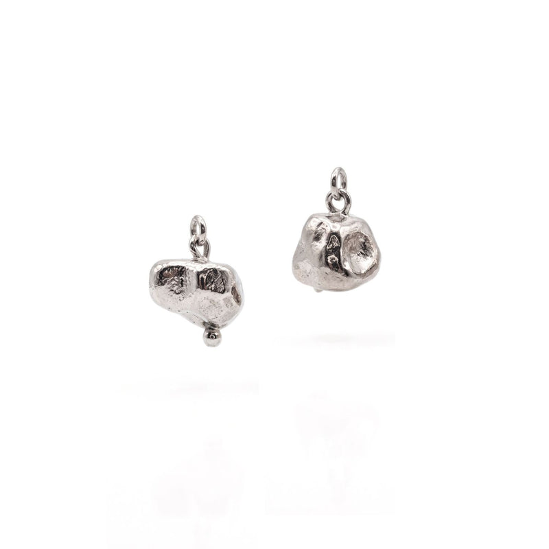 Isolated flat lay of the JAREDJAMIN Silver Nugget Earring Charms on a clean white surface, showcasing the organic, unpolished silver-plated nugget silhouettes and top suspension loops.