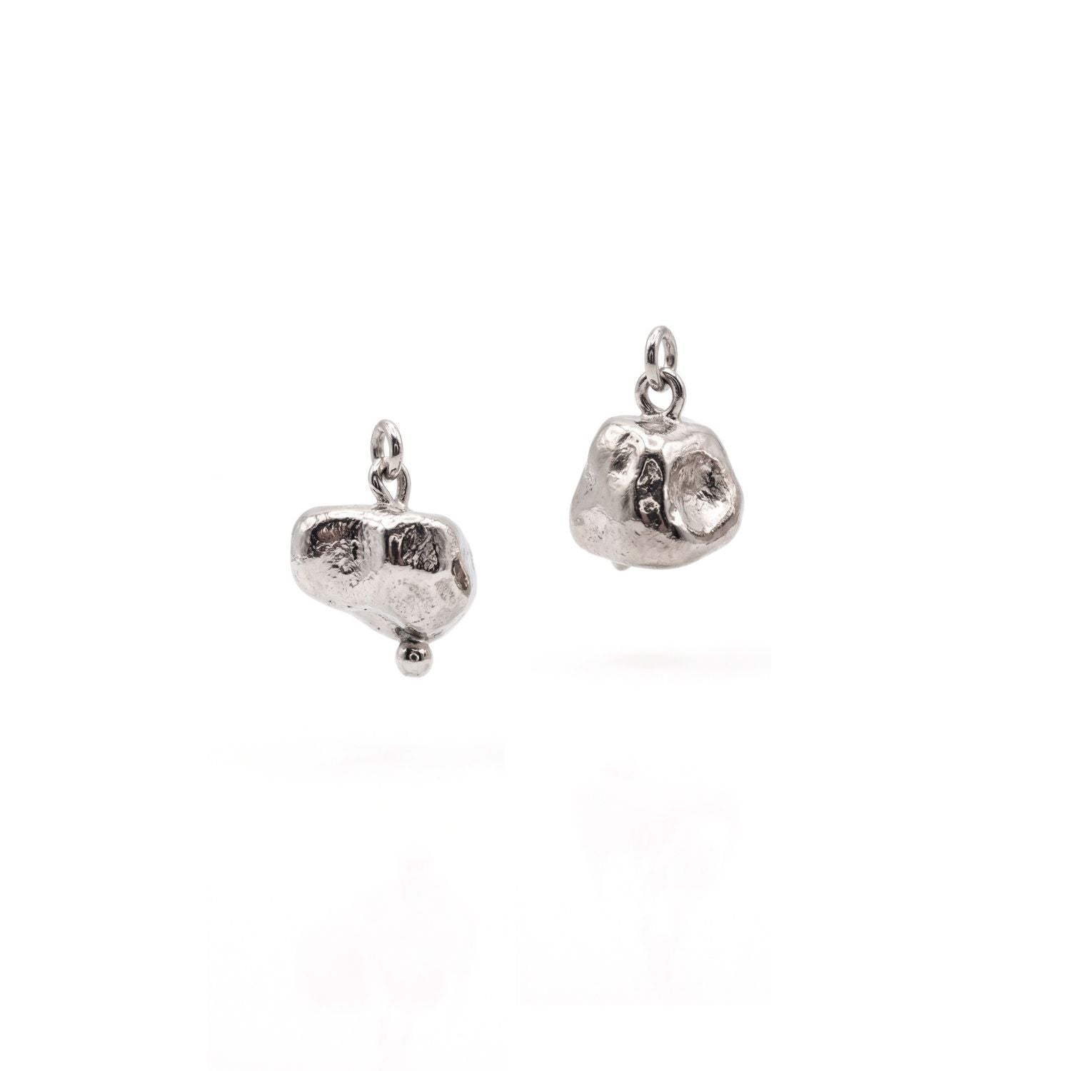 Isolated flat lay of the JAREDJAMIN Silver Nugget Earring Charms on a clean white surface, showcasing the organic, unpolished silver-plated nugget silhouettes and top suspension loops.