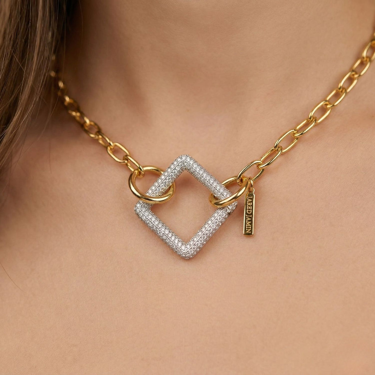 Chain Reaction Connector Necklace—hand-assembled in our West Hollywood studio. Gold links articulate along the neck, punctuated by a gem-laden Silver Pavé Square Clicker Clasp and engraved gold tag. Small-batch, eco-conscious. Style Note: transitions from tailored shirting to silk slips.
