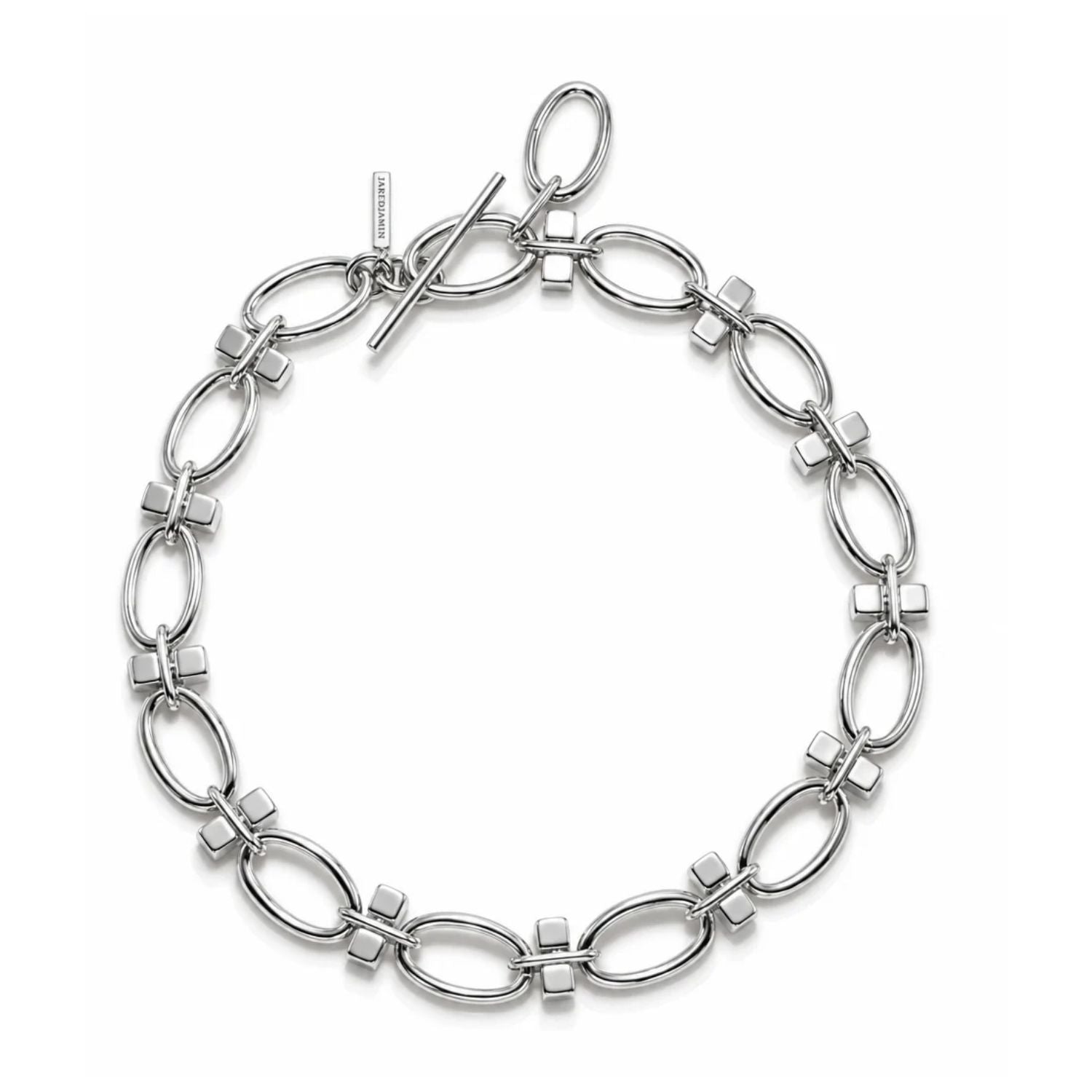Silver link chain choker necklace with oval links and squared block connectors, toggle clasp visible, arranged in a circle on a white background, flat lay.