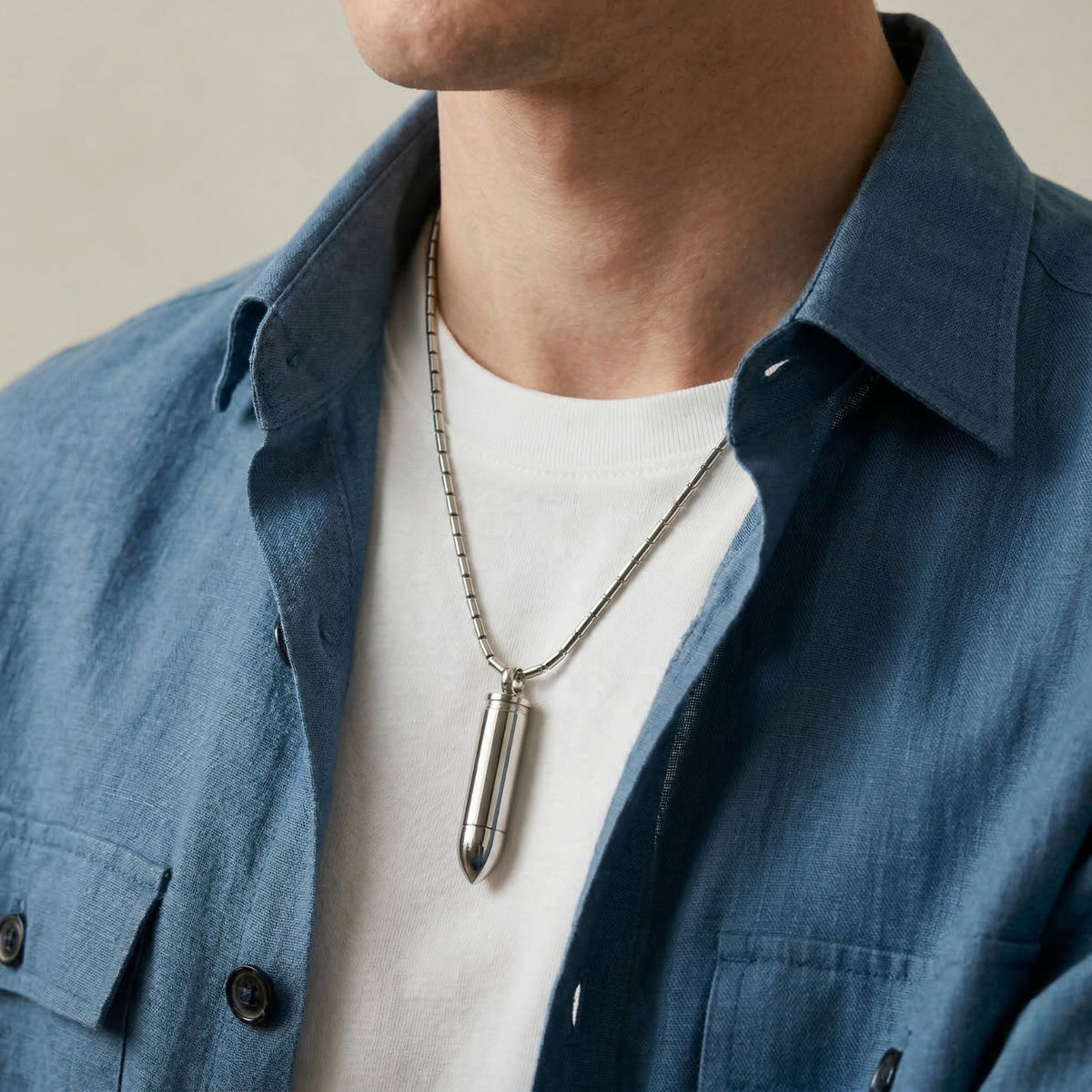 Hand-assembled in our West Hollywood studio, the Scaramanga Capsule Necklace punctuates a blue shirt and white tee with its stainless steel bullet silhouette and hidden compartment—crafted in small batches using eco-conscious methods. Style Note: transitions effortlessly from tailored layers to statement evening looks.