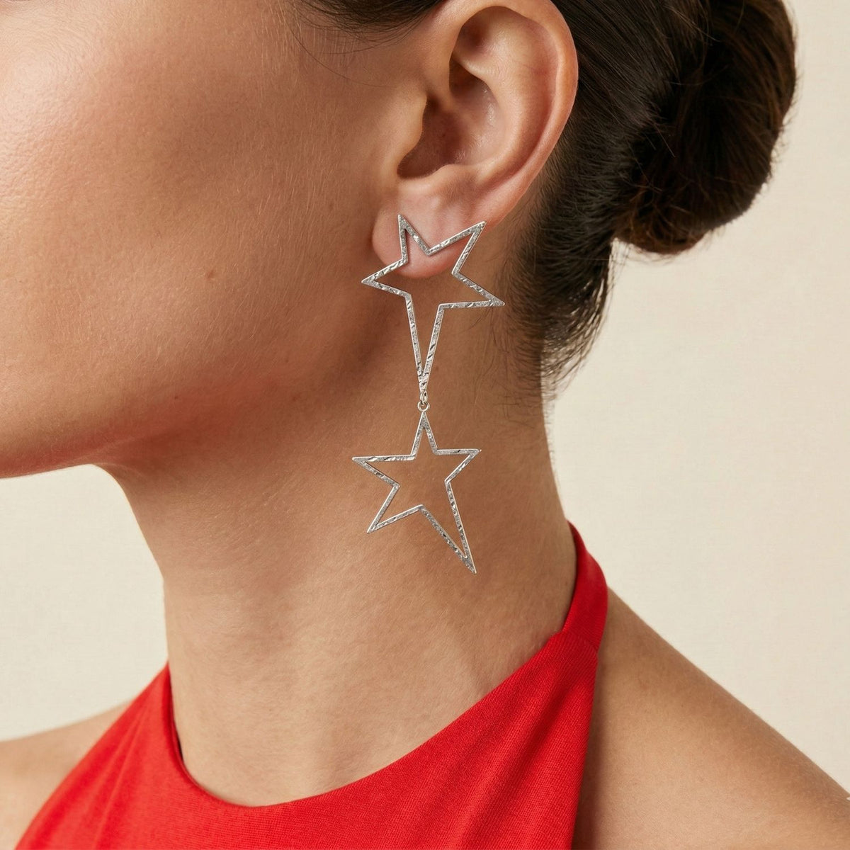 Silver Shooting Star Dust Dangle Post Earrings, expertly crafted from hammered silver with signature brushed finishes, are showcased against a neutral beige background. An artisanal JAREDJAMIN Essential: small-batch, sustainable West Hollywood luxury.