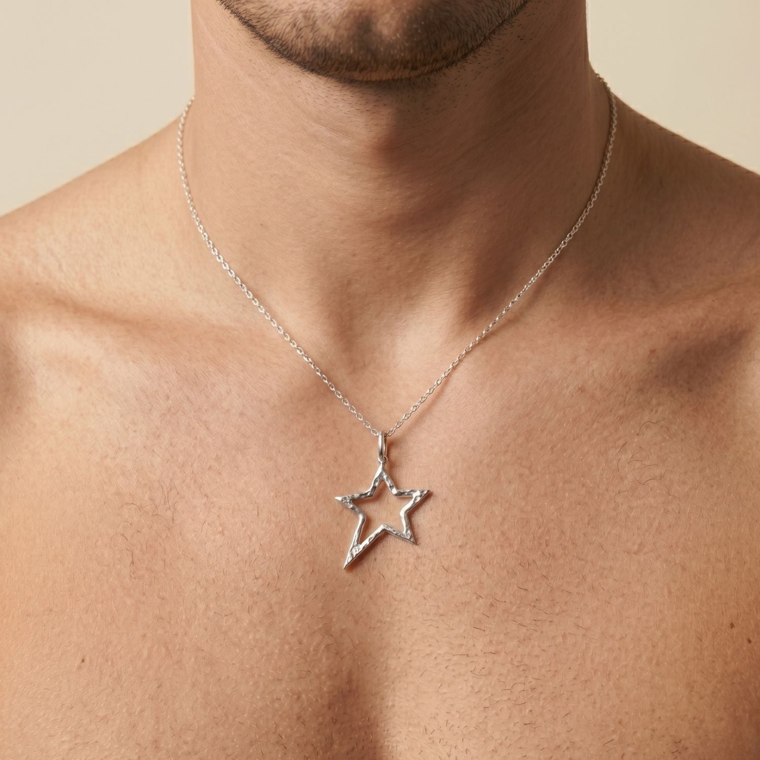 The Silver Shooting Star Pendant Charm sm by JAREDJAMIN Jewelry Online features a rhodium-plated, hollow five-pointed star with textured edges and a top loop—perfect as a unique necklace charm. Shown on a plain white background.