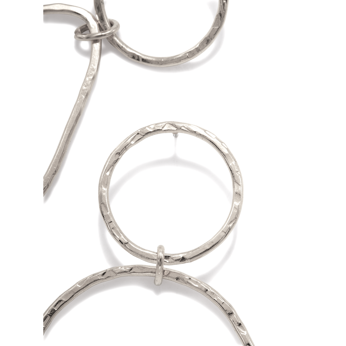 Close-up of a silver necklace with hammered metal rings in an overlapping, geometric pattern—perfect to pair with JAREDJAMIN Jewelry Online’s Silver Textured Tear Post Earrings for a coordinated, artisanal look.
