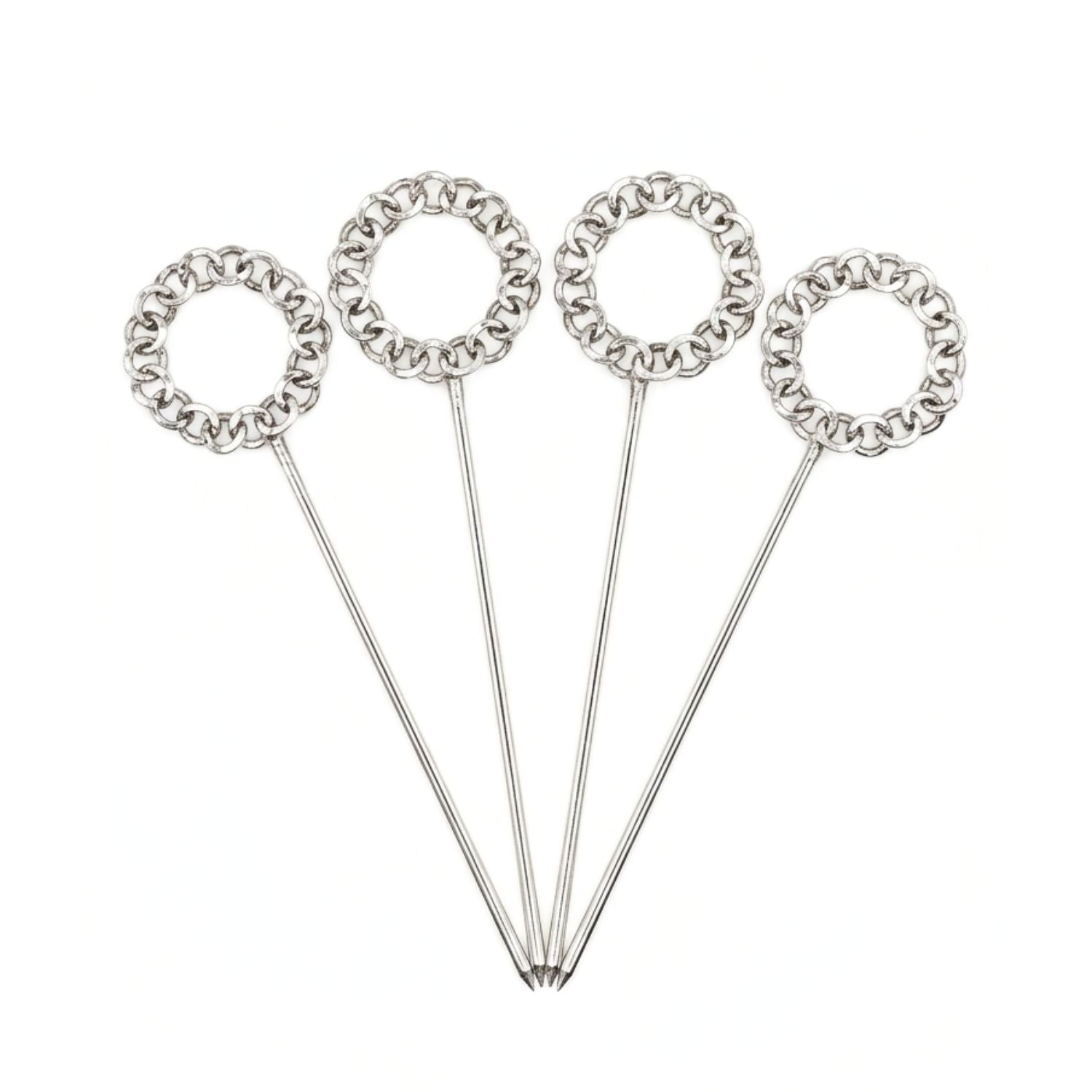 Studio product shot of the JAREDJAMIN Silver Wreath Cocktail Skewers set against a clean background, highlighting the four uniform, polished silver-plated piques with their distinct interlocking chain-link wreath handles arranged in a wide fan layout.