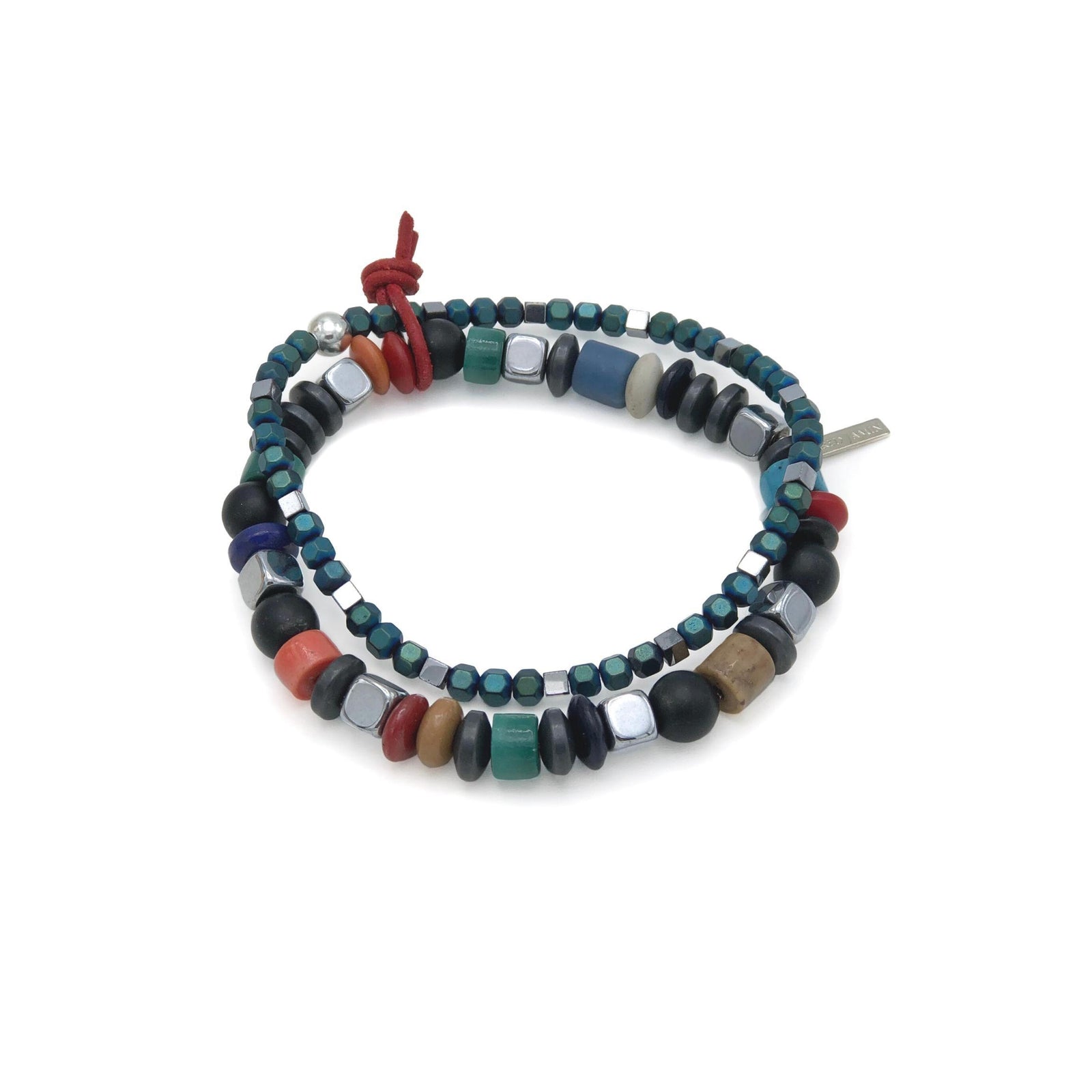 The Sloan Square Stretch Bracelet Set by JAREDJAMIN Jewelry Online features colorful round and square teal, red, green, black onyx gemstone, and silver beads with a red knot and metallic tag for a chic, eclectic style.