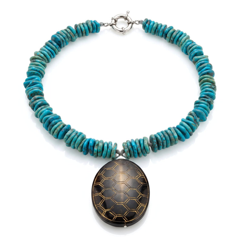 Studio product shot of the 17-inch JAREDJAMIN Solana Turquoise Howlite & Carved Jade Pendant Collar Necklace displayed flat in a loop, showing the turquoise disc beads, carved brown jade oval, and silver spring-ring clasp.