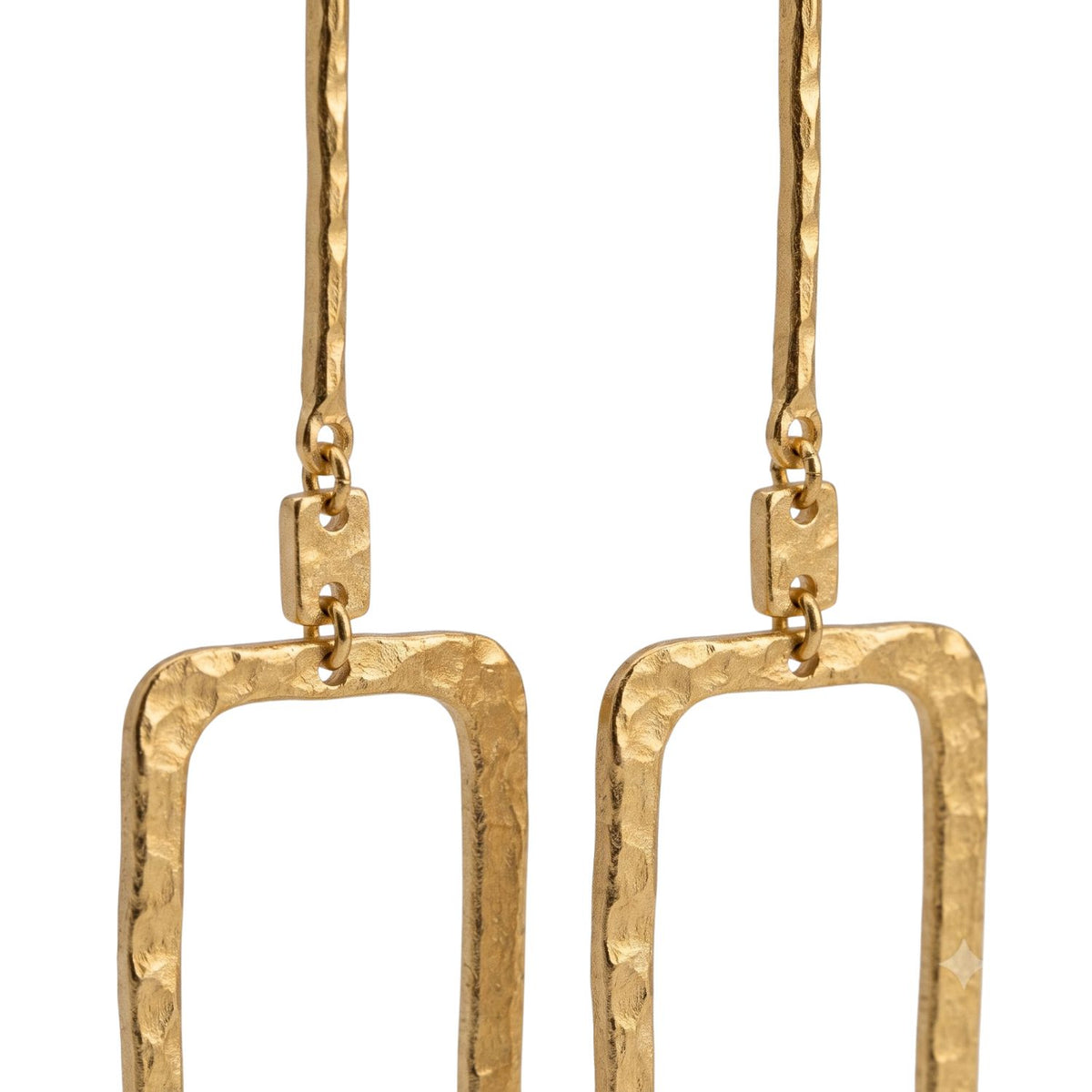 Close-up studio shot focusing on the hand-hammered texture of the open rectangular links and the lower bar connection of the Solene single link drop earrings.