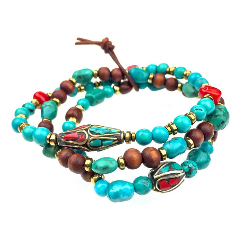 The South Western Guardian Set by JAREDJAMIN Jewelry Online is a triple-wrap bracelet featuring turquoise, brown wooden, gold beads, and red and turquoise ovals with metallic inlays plus gemstone accents. Finished with a brown leather cord knot.