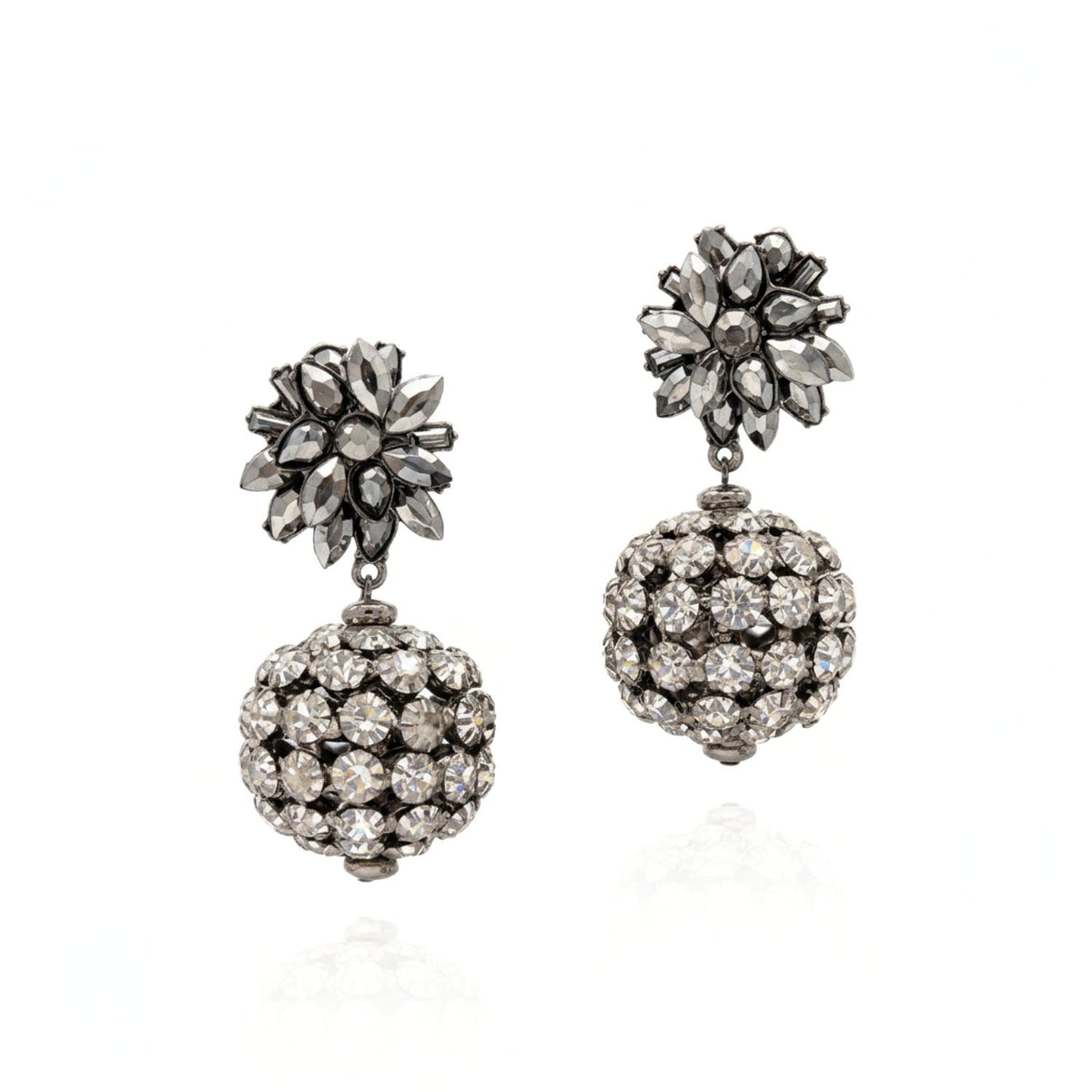 High-resolution studio product shot of the Sparkling Bloom Earrings displayed front-facing on a white background, showcasing the grey crystals on the pewter-cast floral motif and the clear crystal spheres.