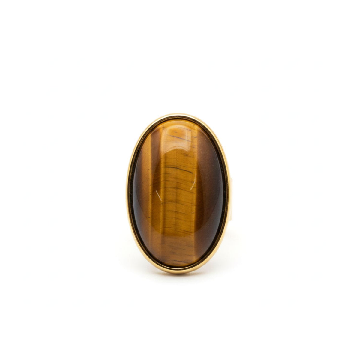 The Stella Statement Ring in Tiger's Eye by JAREDJAMIN Jewelry Online features an oval, golden-brown striped stone in a simple 18K gold-plated adjustable bezel, shown upright on white. This piece brings natural elegance to any look.