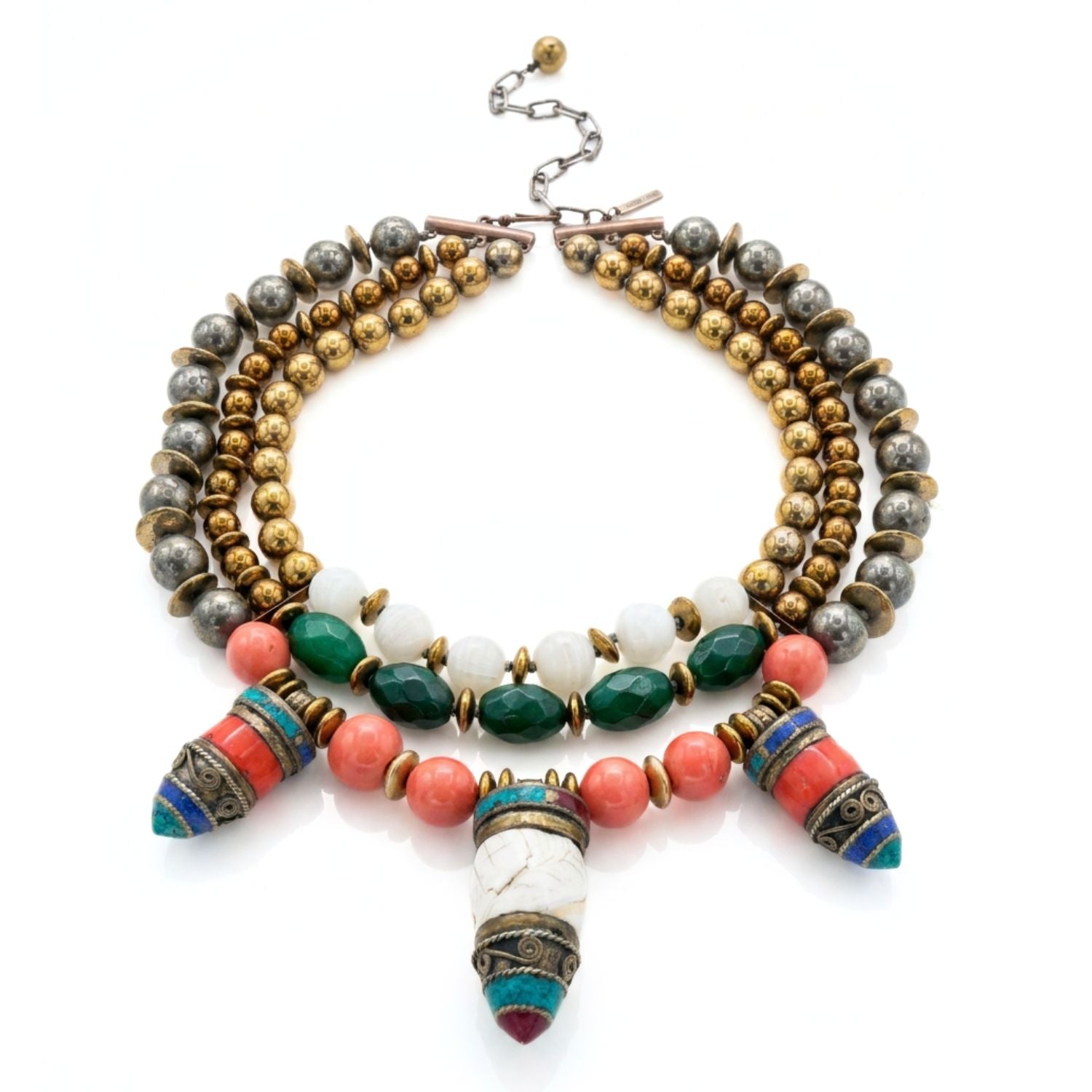 Studio product shot of the Tibetan Tide multi-strand collar necklace displayed flat in a full loop against a white background, showing the gold hematite strands, hand-knotted construction, and hook-and-extension clasp with brand tag.
