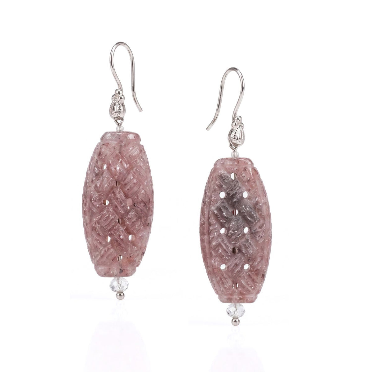 Side view of a model wearing the 2.75-inch Carved Sandstone Trellis Earrings, demonstrating their architectural scale, organic color palette, and elegant vertical drape paired with an asymmetric coral pink top.