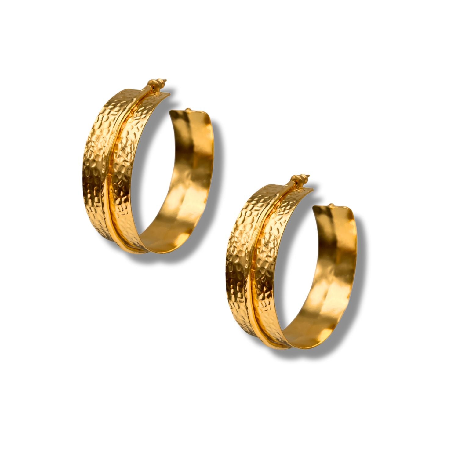 The Tribella Textured Hoop Earrings by JAREDJAMIN Jewelry Online feature 18k gold plating, a hammered texture with a smooth center band, and a latch-back closure—creating an elegant statement piece that casts soft shadows on any background.