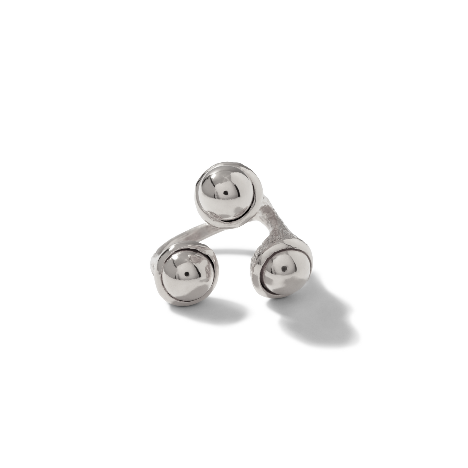 The Silver Trinity Acorn Ring by JAREDJAMIN Jewelry Online features three textured, flared silver bands ending in polished spheres. Displayed on a white background with a soft right shadow, this modern, sculptural ring offers an adjustable fit.
