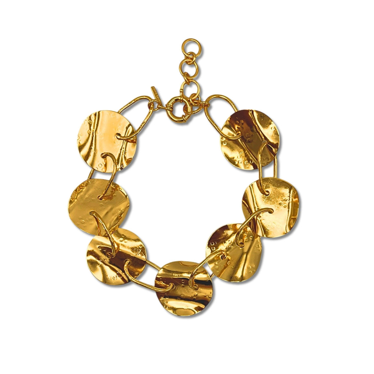 The Gold Viviane Necklace by JAREDJAMIN Jewelry Online features seven large, round hammered discs linked by elongated loops and a circular clasp, highlighting handcrafted metalwork on a white background.