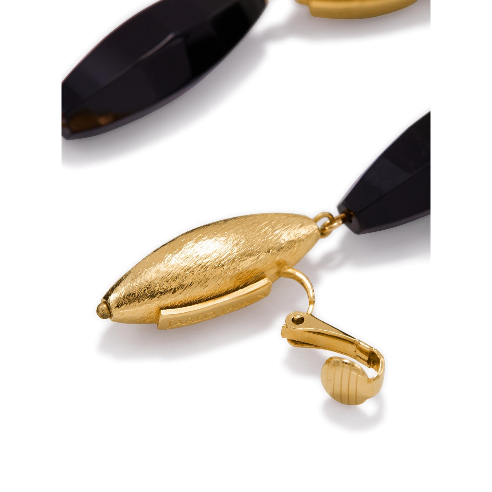 Gold Isla Onyx Clip On Earrings by JAREDJAMIN: 18K gold plated, brushed texture oval studs with faceted black onyx drops. Artisanal craftsmanship small-batch/West Hollywood, sustainable luxury, signature finish. Displayed on white.