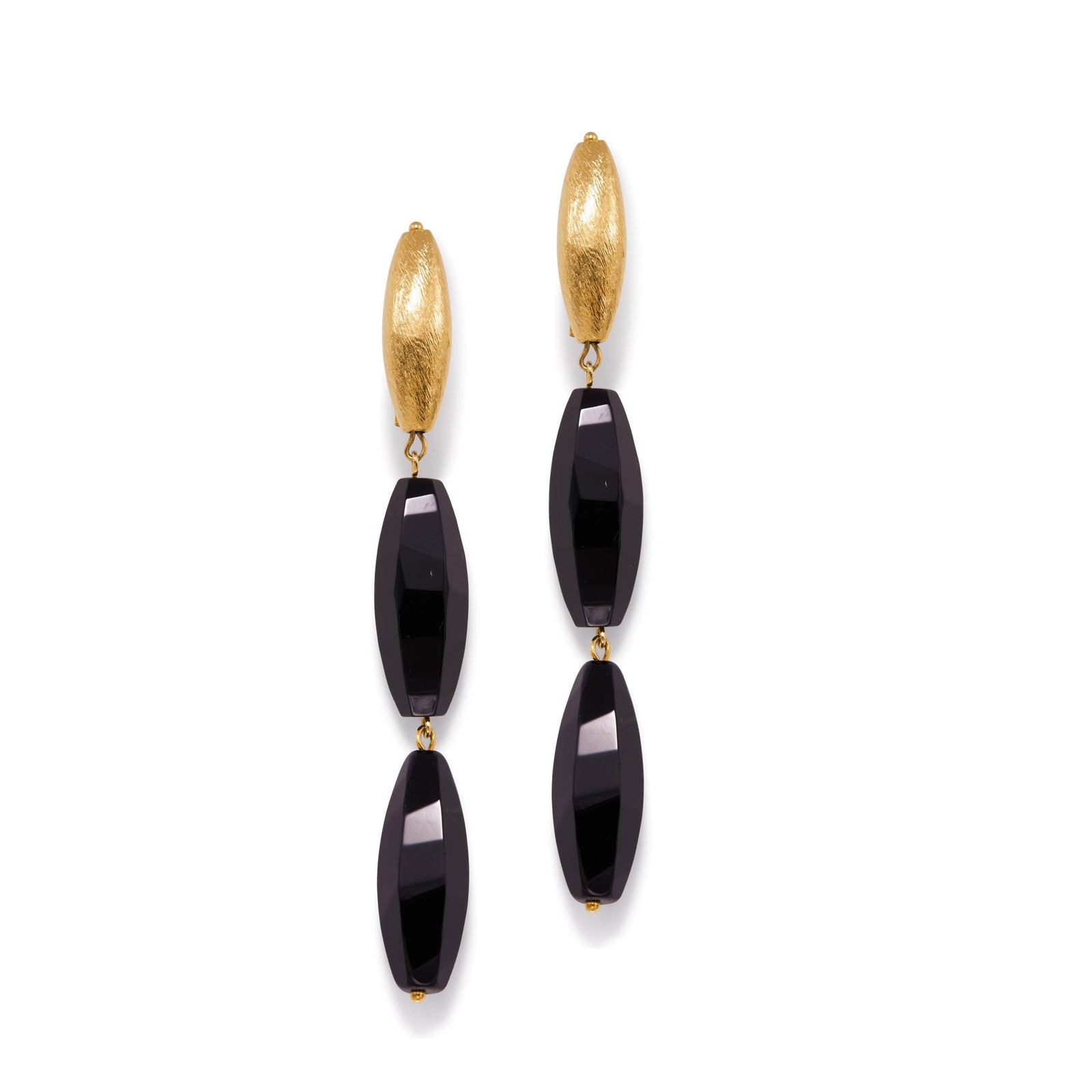 The Zeppelin Gold Isla Onyx Clip On Earrings by JAREDJAMIN Jewelry Online feature brushed 18K gold textured oval posts with two elongated, faceted onyx beads linked vertically, shown against a white background.