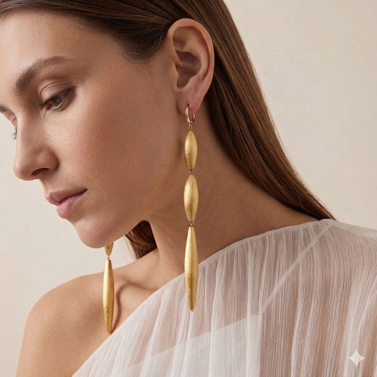 Zeppelin Cora 3 Drop Gold Leverback Earrings by JAREDJAMIN, crafted in gold with a signature brushed finish, are showcased. JAREDJAMIN Essential: artisanal craftsmanship West Hollywood, sustainable luxury, unique texture.