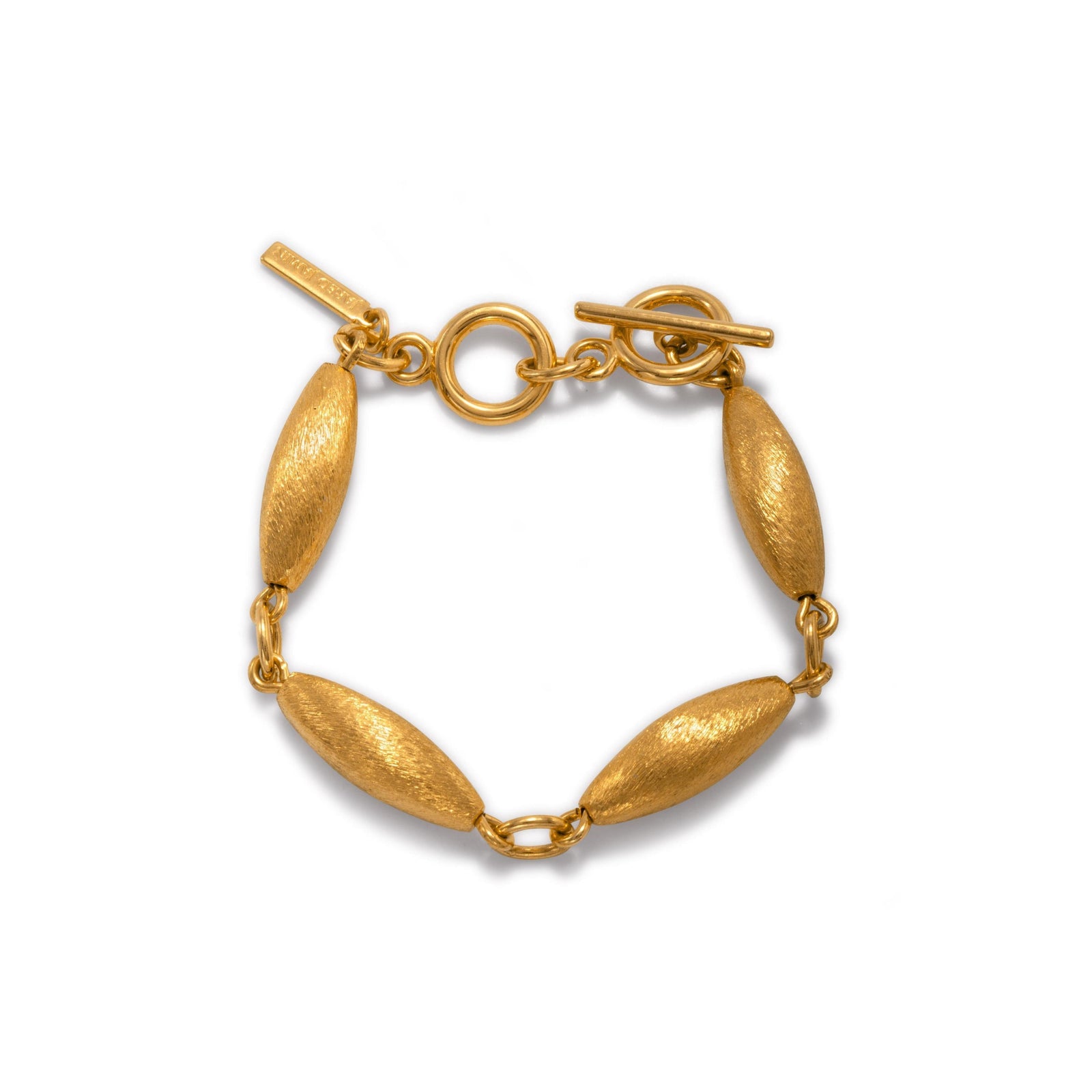 The Zeppelin Phoebe Gold Bracelet by JAREDJAMIN Jewelry Online features four 18K goldplated, zeppelin-shaped beads linked by round connectors, a toggle clasp with a circular ring and bar, and a small rectangular tag near the clasp. Displayed on a white background.