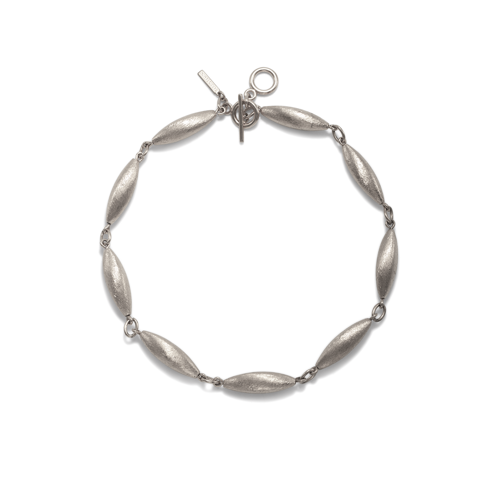 The Zeppelin Phoebe Silver Necklace by JAREDJAMIN Jewelry Online features eight elongated blimp beads linked with a toggle clasp, inspired by retro-chic design and displayed in a loose circle on a white background.