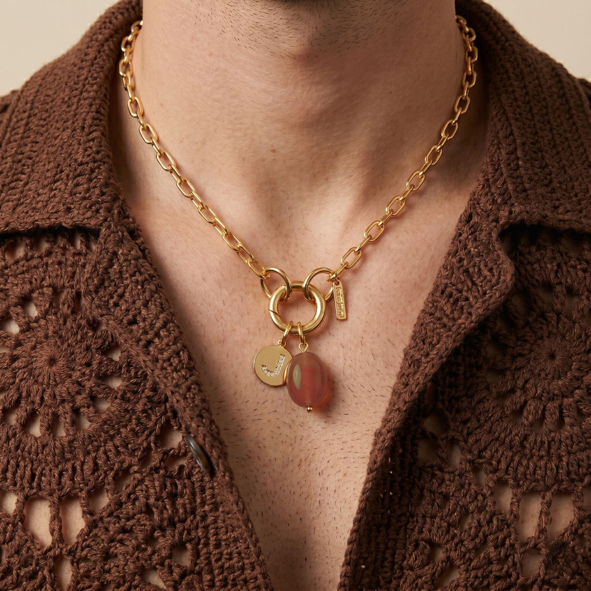 Hand-assembled in our West Hollywood studio, this carnelian pebble necklace punctuates a brown crochet shirt with sculpted gold charms and twin round pendants. Crafted in small, eco-conscious batches. Style Note: transitions seamlessly from knitwear to silk cocktail looks.