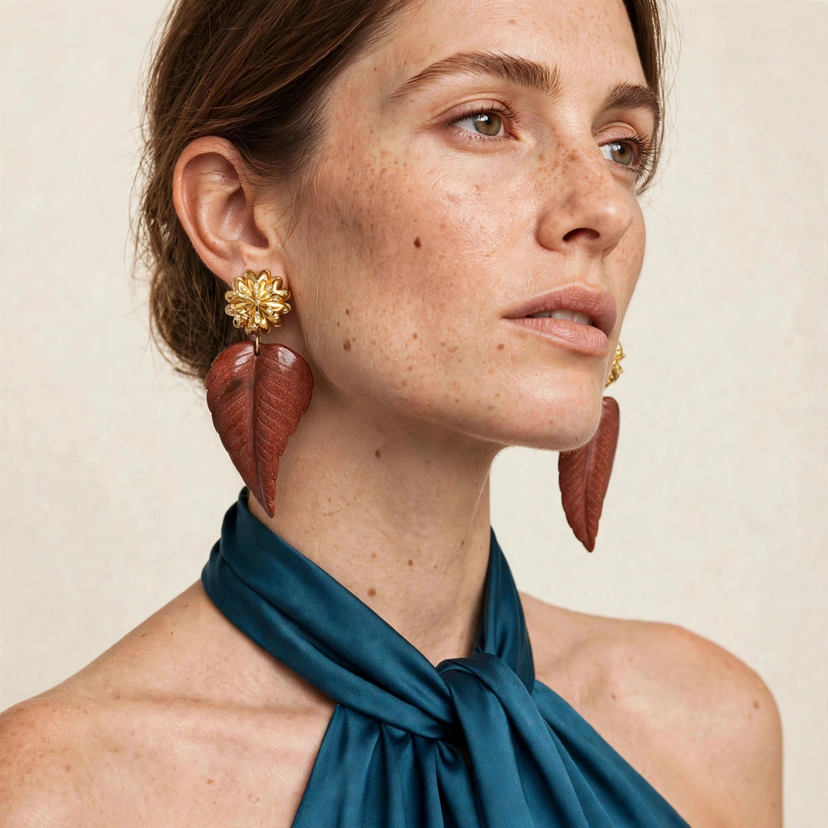 Model wearing the JAREDJAMIN Chrysanthemum Clip on Earrings Sandstone with 18k gold-plated chrysanthemum tops and sparkling gold sandstone leaf drops.