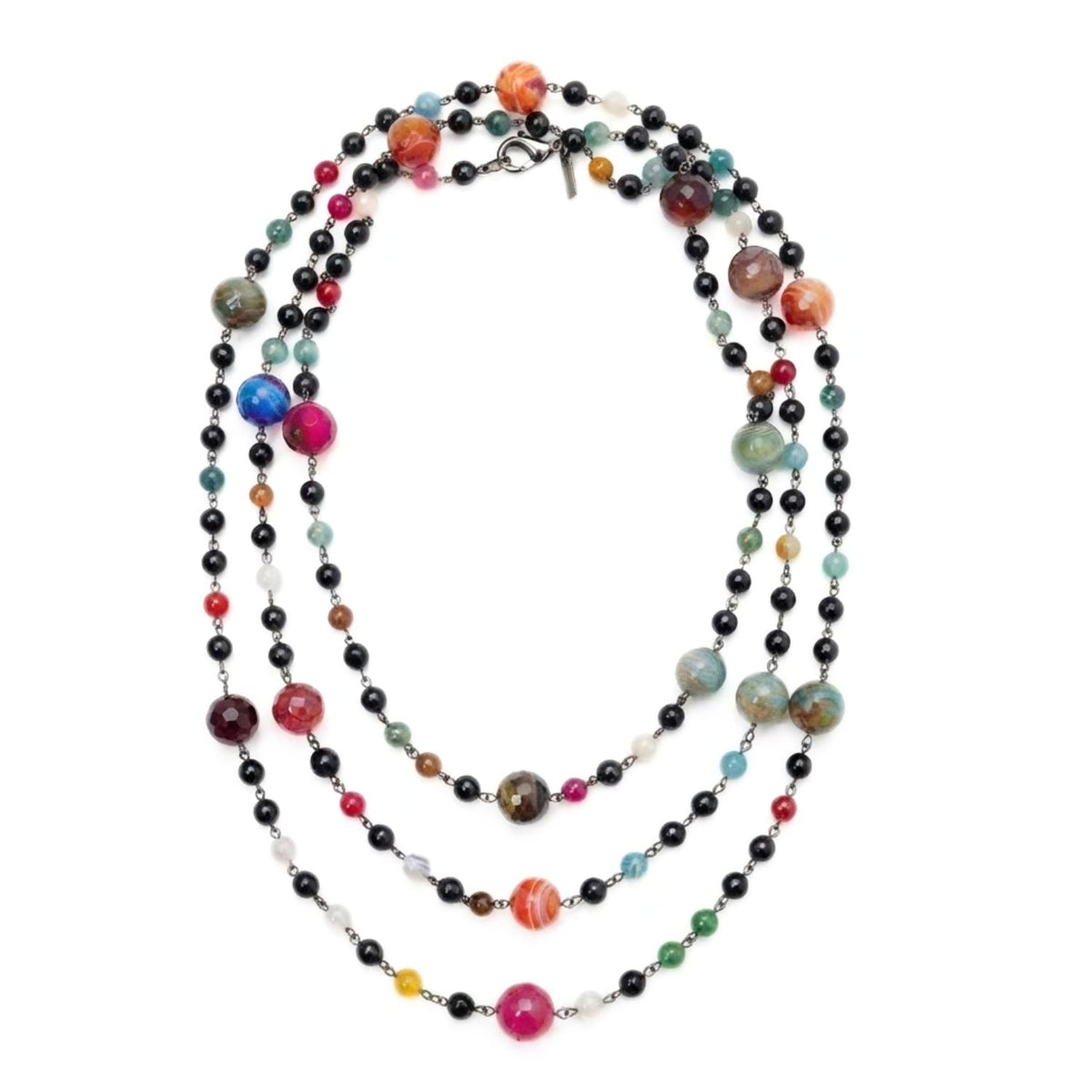 High-resolution studio top shot of the Caelum Cosmic Strand elegantly coiled in multiple circular tiers on a white background, highlighting the contrast between the dark gunmetal wire and the colorful gemstone planet spheres.