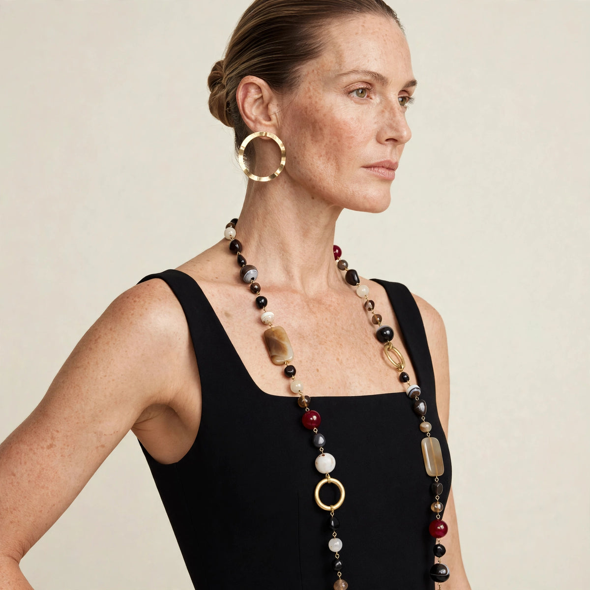 Close-up of gold duet post earrings on model