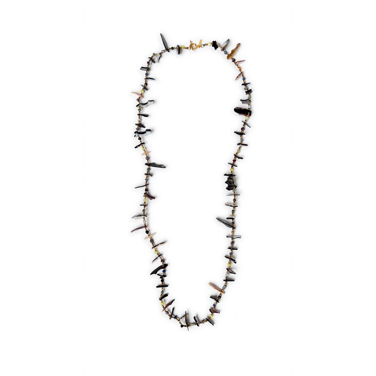 Caracola shell shard necklace laid in a long open oval on a white background, full view