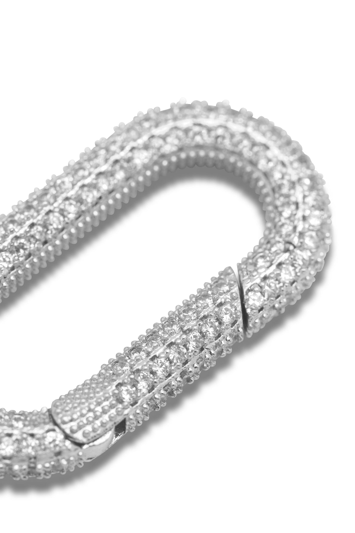A close-up of a silver-plated Oval Pavé Clicker Clasp with beaded texture and sparkling cubic zirconia by JAREDJAMIN Jewelry Online, partially open—perfect for accenting a pendant chain, shown on a white background.