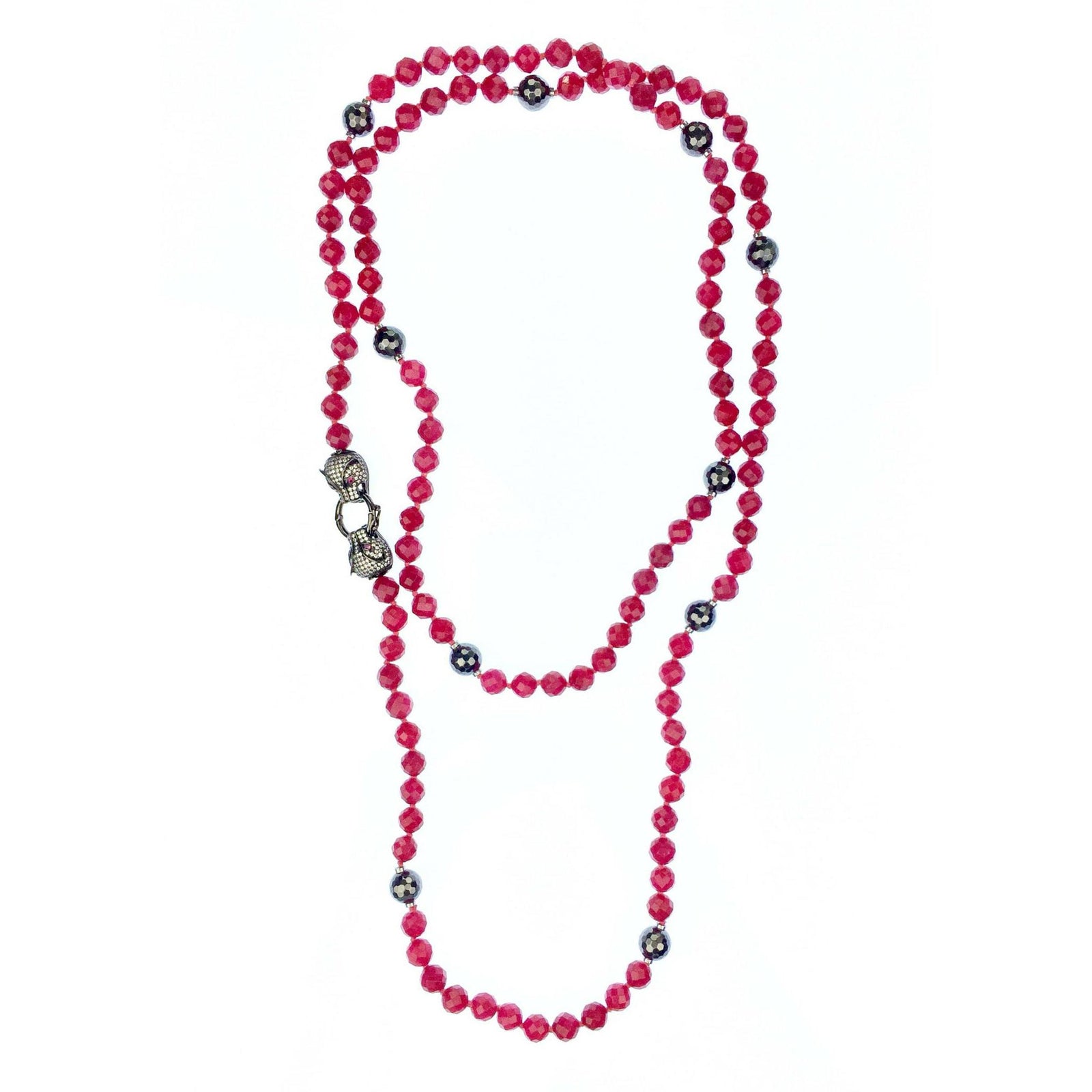 The Prying Panthers Necklace by JAREDJAMIN Jewelry Online features faceted raspberry Quartz beads, ornate silver-toned accents, and a decorative CZ pave clasp with intricate silver detailing, elegantly arranged in loose loops.