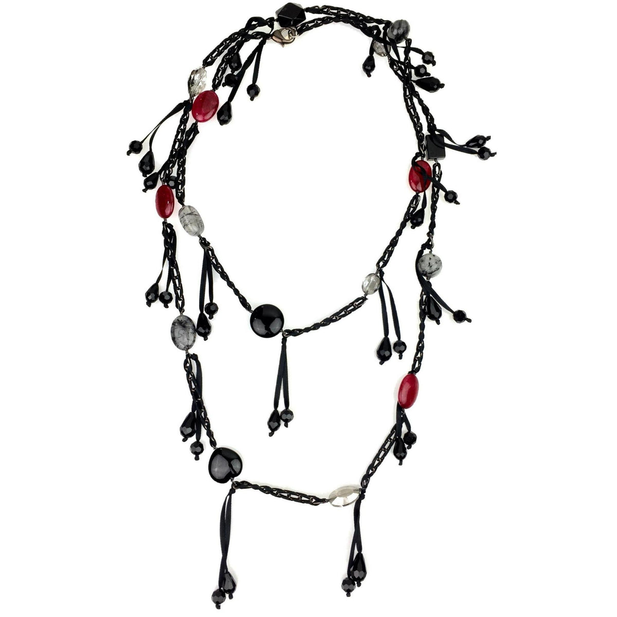The See You Saloon Necklace by JAREDJAMIN Jewelry Online features twisted black strands with red, black, and clear oval beads, a gunmetal-tone chain, dangling bead clusters, and teardrop-shaped black beads for an elegant statement look.